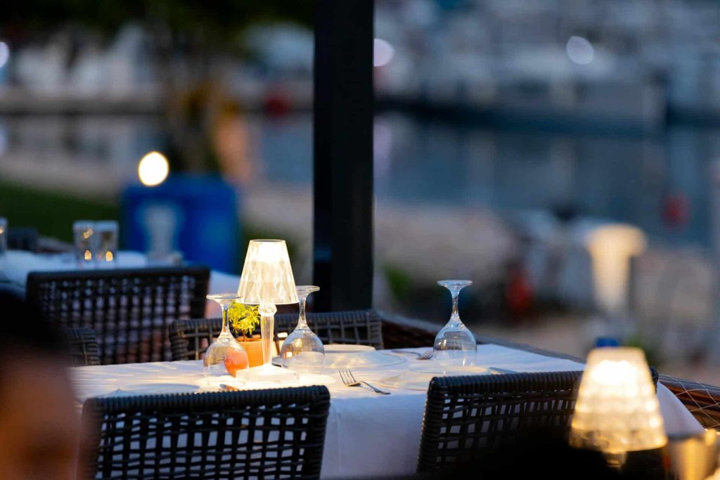 a restaurant table with white table cloths and wine glasses