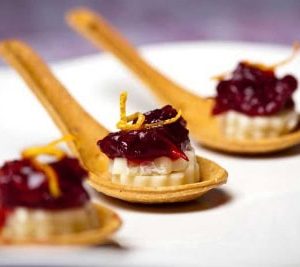 Delectable brie, chutney, orange zest on eco-friendly cranberry spoons from FlavorFulz.