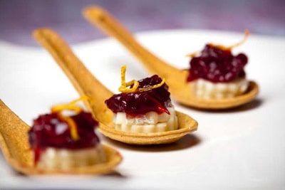 Delectable brie, chutney, orange zest on eco-friendly cranberry spoons from FlavorFulz.