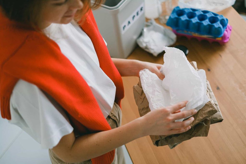 Woman sorting out rubbish in daytime